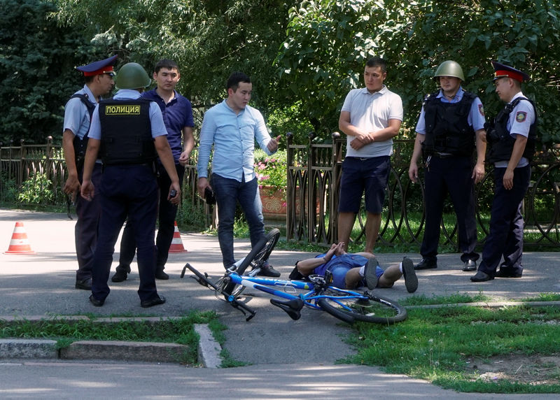 © Reuters. Police officers detain a man after an attack in the centre of Almaty, Kazakhstan