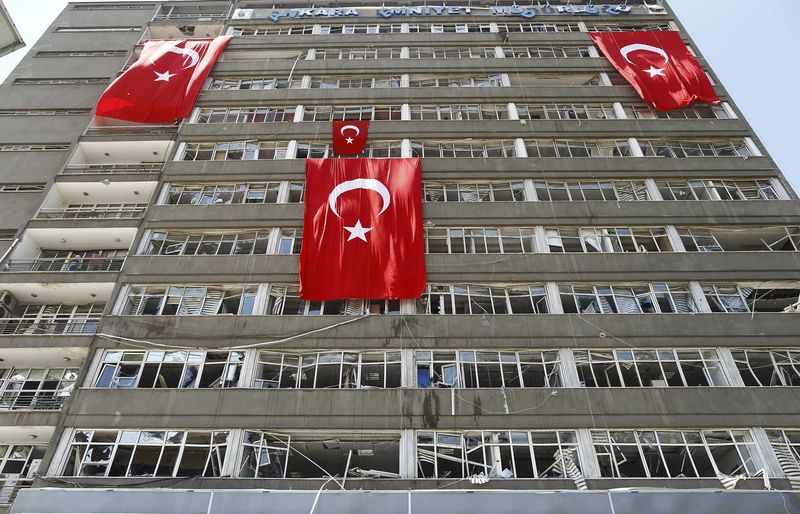 © Reuters. Turkish flags hang on the facade of the damaged building of police headquarters in Ankara