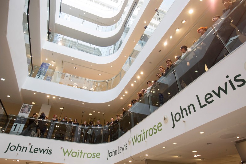 © Reuters. John Lewis and Waitrose employees wait for the announcement of their 2015 bonus in central London