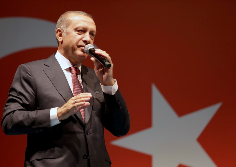 © Reuters. Handout photo of Turkish President Erdogan addressing his supporters outside of his residence in Istanbul