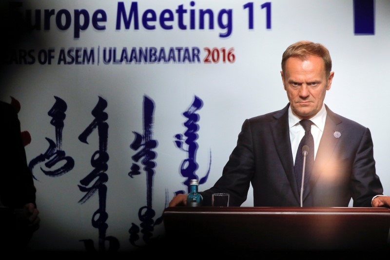 © Reuters. Donald Tusk listens to reporters questions in Ulaanbaatar