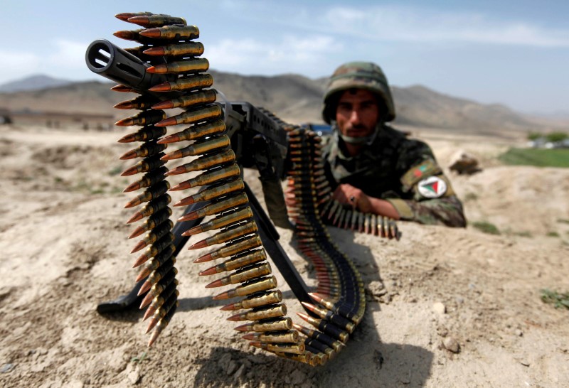 © Reuters. An Afghan National Army soldier holds a position while patrolling the village of But Khak on the outskirts of Kabul