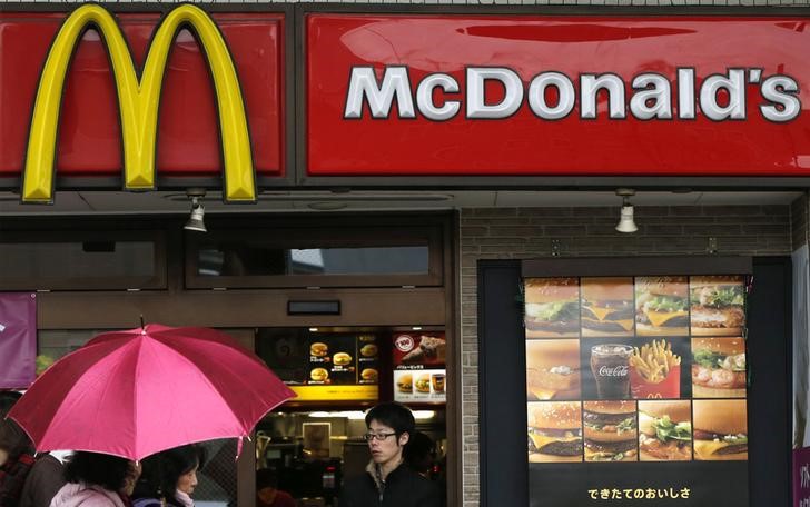 © Reuters. Passersby walk past a McDonald's store in Tokyo