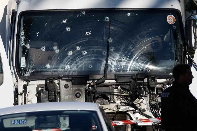 © Reuters. Bullet imacts are seen on the heavy truck the day after it ran into a crowd at high speed killing scores celebrating the Bastille Day July 14 national holiday on the Promenade des Anglais in Nice