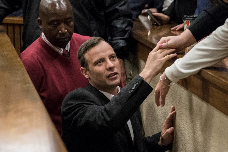 © Reuters. Olympic and Paralympic track star Oscar Pistorius leaves the court after his sentence hearing at the North Gauteng High Court in Pretoria