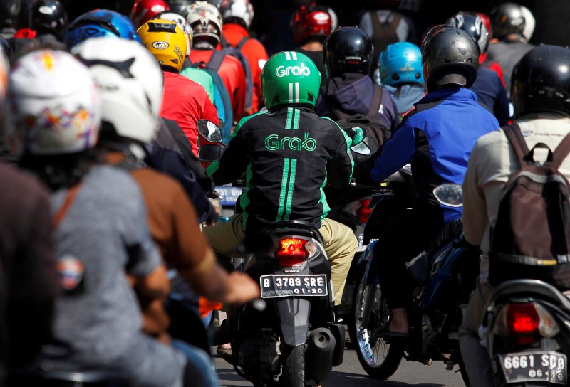 © Reuters. A Grab bike rider is seen during rush hour traffic in Jakarta