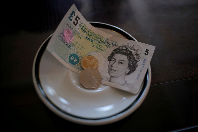 © Reuters. An English five Pound note and coins are seen at a restaurant in the British overseas territory of Gibraltar