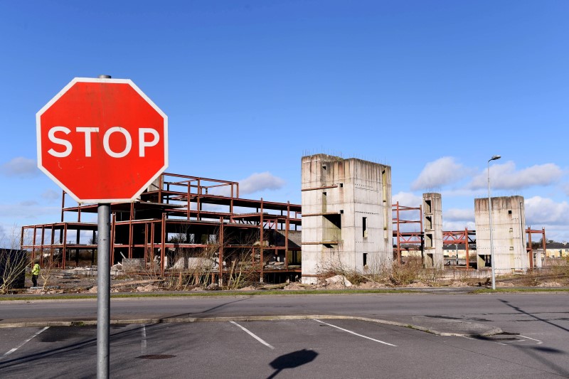 © Reuters. A road sign stands in front of a building site for a hotel that was never completed in Edenderry, Ireland