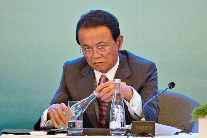 © Reuters. Taro Aso, Japan's Deputy Prime Minister, attends a panel for the High-level Tax Symposium held in Chengdu