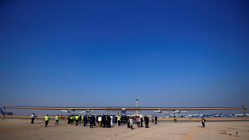 © Reuters. Solar Impulse 2, a solar powered plane, is surrounded by journalists and media after its landing at Cairo Airport