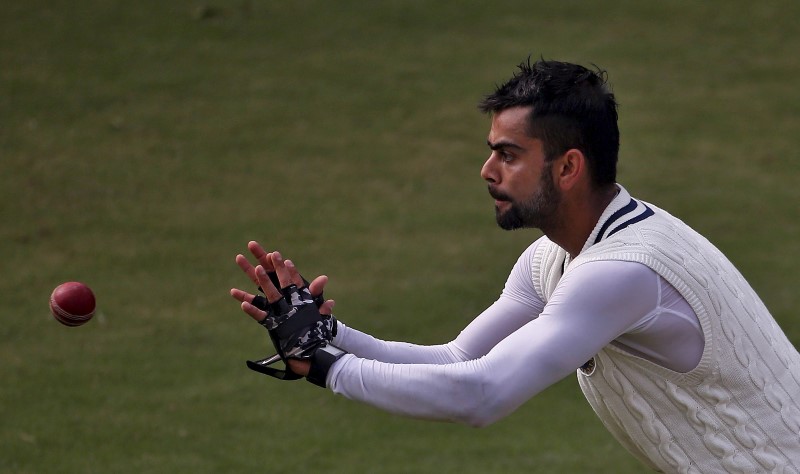 © Reuters. India's captain Kohli prepares to catch the ball during a practice session ahead of their fourth and final test cricket match against South Africa in New Delhi