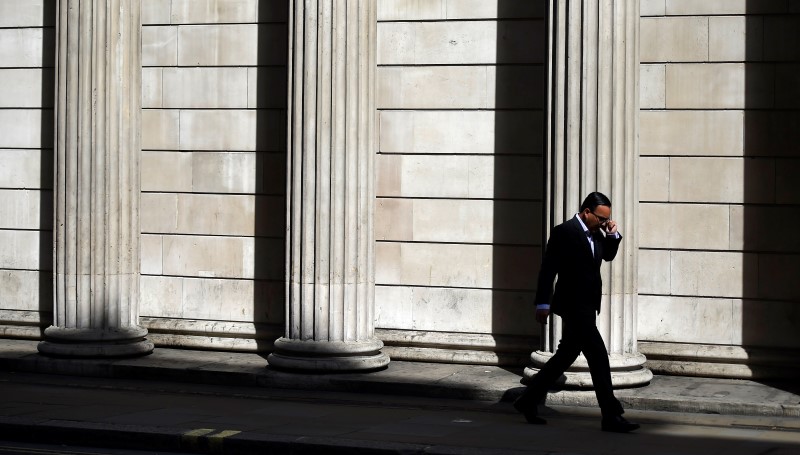 © Reuters. File photo of a man speaking on his phone outside the Bank of England in London