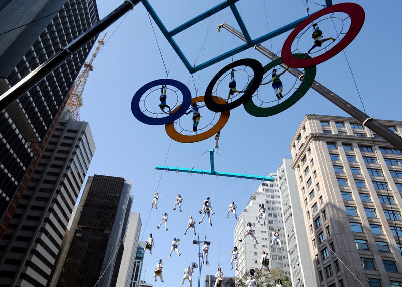 © Reuters. Acrobats perform on the Olympics rings at Paulista Avenue in Sao Paulo's financial center