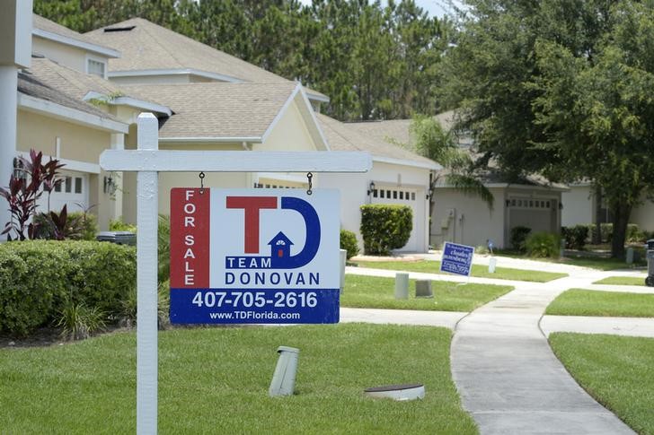 © Reuters. For Sale signs stand in front of houses in a neighborhood where many British people have purchased homes