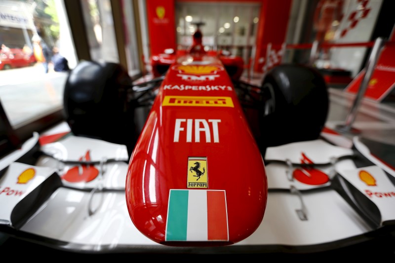 © Reuters. Ferrari and Fiat logos and a Italian flag are pictured on a replica of a Ferrari Formula One car in Santiago