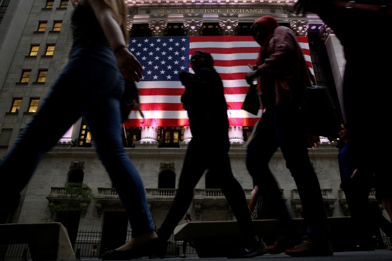 © Reuters. People pass by the NYSE in the financial district  of New York