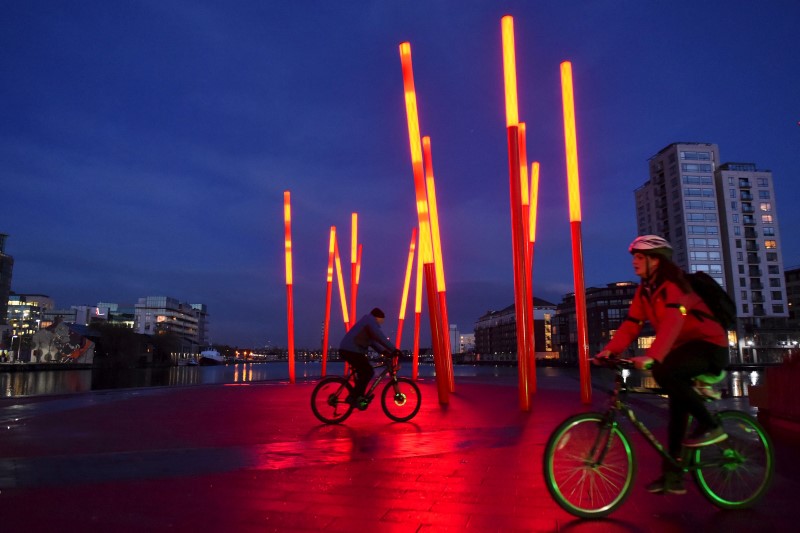 © Reuters. Cyclists ride dublinbikes in Dublin's docklands area
