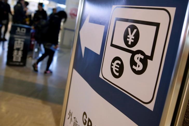 © Reuters. Currency signs of Japanese Yen, Euro and the U.S. dollar are seen on a board outside a currency exchange office at Narita International airport