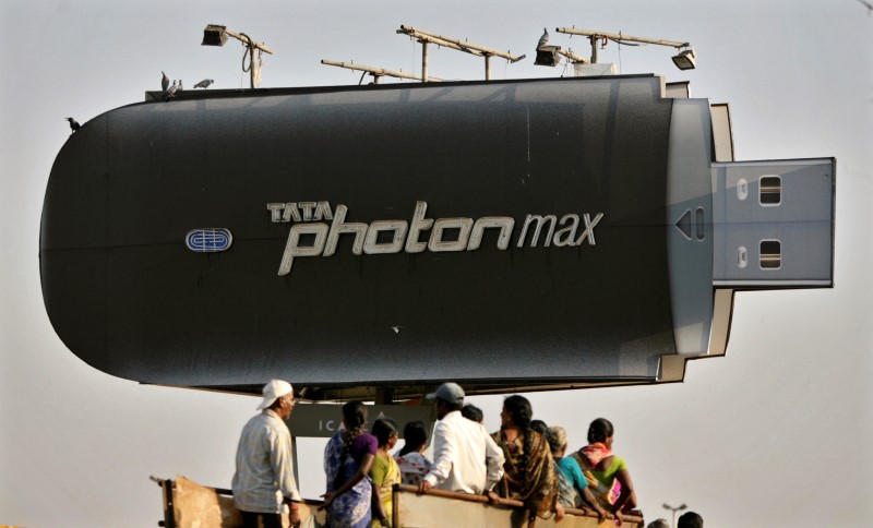 © Reuters. People travel in a truck under a large advertisement of Tata's wireless internet device in Hyderabad