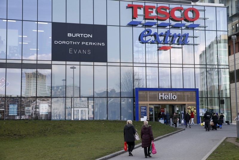 © Reuters. File photo of people walking past a Tesco Extra store in Woolwich, southeast London