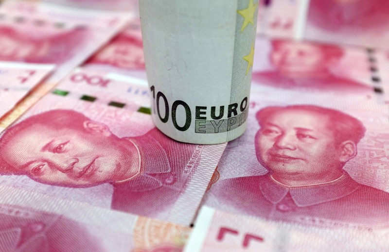 © Reuters. A 100-Euro banknote and Chinese 100-yuan banknotes are seen in this picture illustration, in Beijing