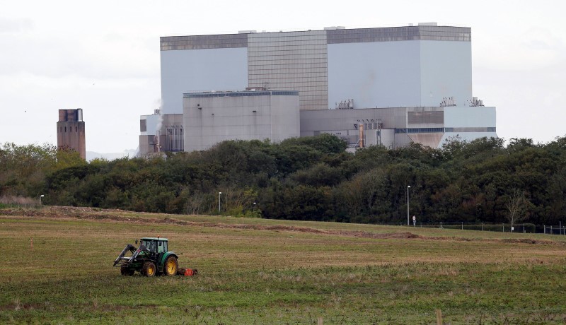 © Reuters. File photo of a tractor mowing a field on the site where EDF Energy's Hinkley Point C nuclear power station will be constructed in Bridgwater