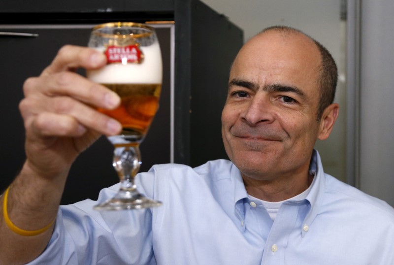 © Reuters. Anheuser-Busch InBev CEO Brito poses with a Stella Artois beer after the annual shareholders meeting in Brussels