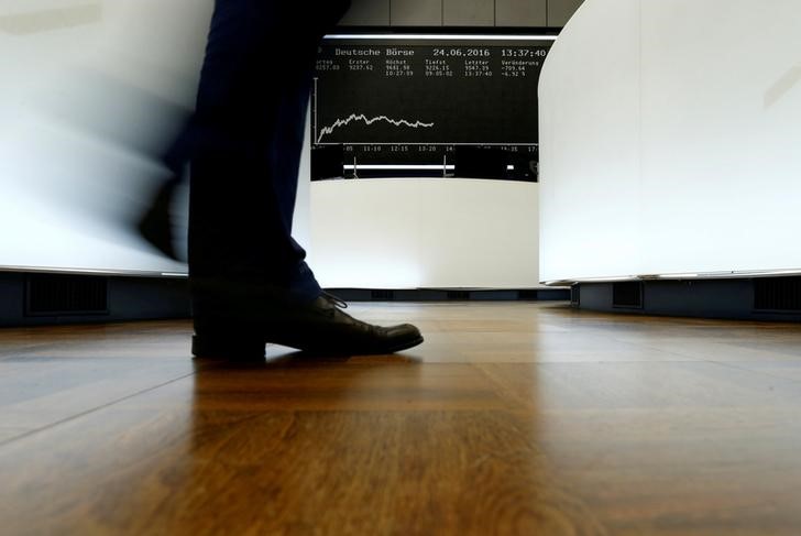 © Reuters. A trader walks past the German DAX Index board on the trading floor at the Frankfurt stock exchange