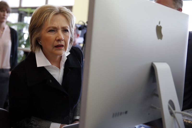 © Reuters. U.S. Democratic presidential candidate Clinton looks at a computer screen during a campaign stop at Atomic Object company in Grand Rapids