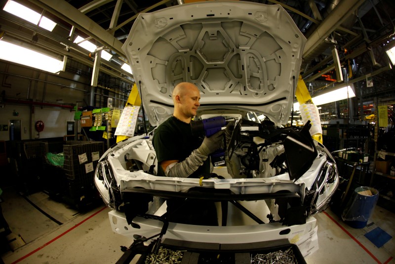 © Reuters. Staff work on the Jaguar XJ production line at their Castle Bromwich Assembly Plant in Birmingham