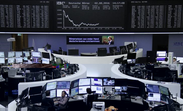 © Reuters. Traders work at their desks in front of the German share price index DAX board in Frankfurt