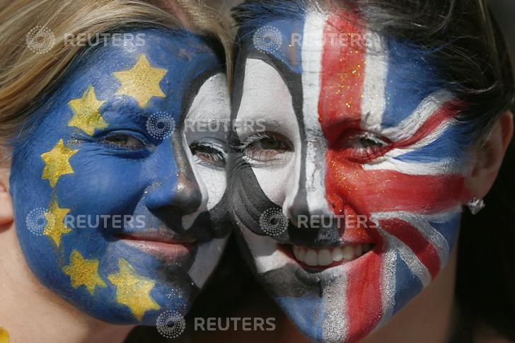 © Reuters. Protestors with their faces  painted pose for a photograph during a demonstration against Britain's decision to leave the European Union, in central London