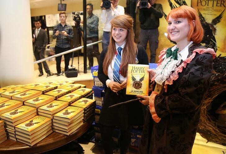 © Reuters. Competition winner Fran Plagge is the first to receive a copy of the book of the play of Harry Potter and the Cursed Child parts One and Two at a bookstore in London