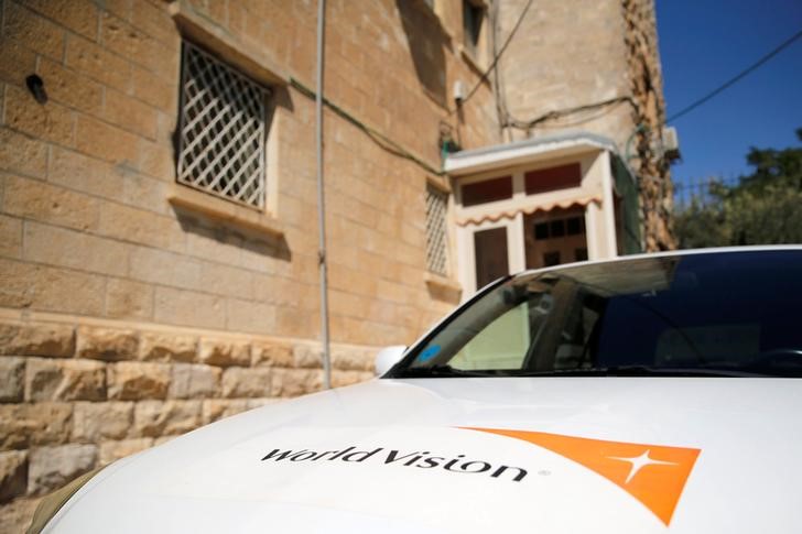 © Reuters. The logo of U.S.-based Christian charity World Vision is seen on a car parked outside their offices in Jerusalem