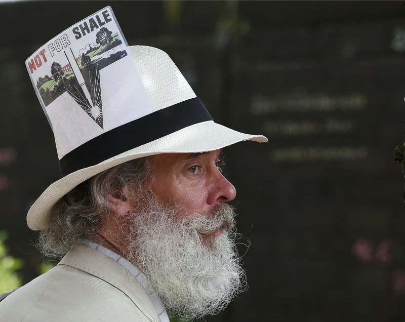 © Reuters. File photo of an anti-fracking protester wearing a message on his hat during a demonstration outside County Hall in Preston