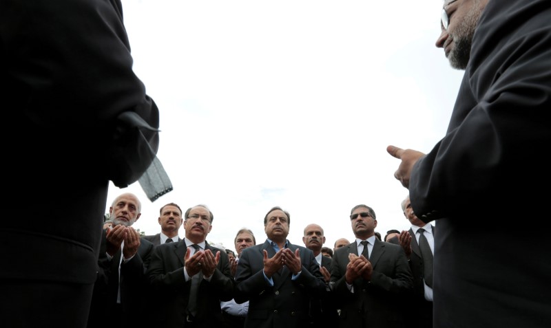© Reuters. Lawyers say prayers for colleagues who were killed in the suicide bomb attack at a hospital in Quetta on Monday, outside the Supreme Court in Islamabad