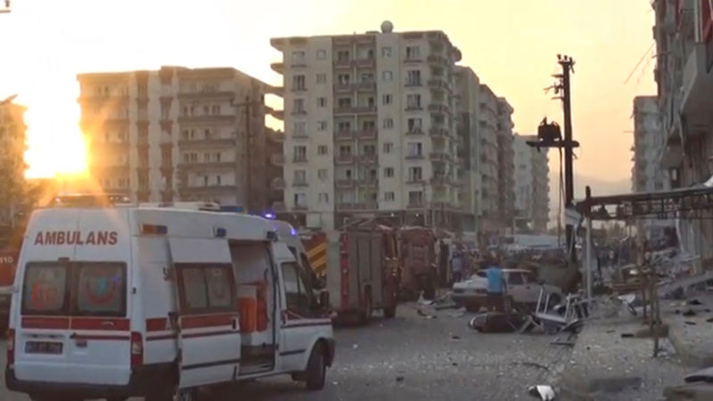 © Reuters. A still image taken from a video footage shows emergency vehicles at the scene of a bomb blast in Kiziltepe