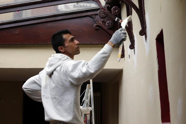 © Reuters. Painter apprentice Haiqar from Afghanistan works at a construction site in Regensburg