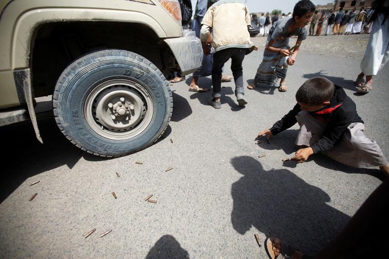 © Reuters. Boys collect spent bullet shells as they attend a tribal gathering for Houthi fighters in Yemen's capital Sanaa