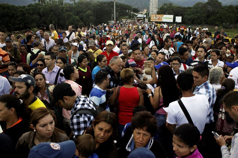 © Reuters. People cross over the Simon Bolivar international bridge to Colombia from San Antonio del Tachira, Venezuela