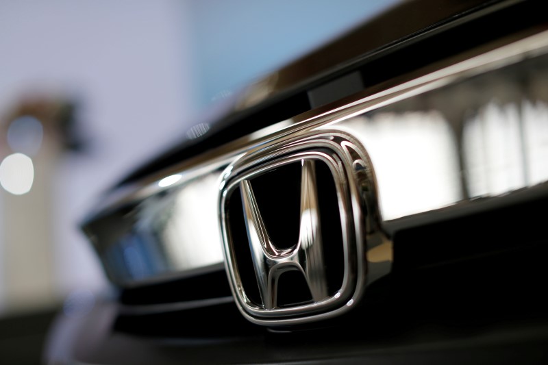 © Reuters. Honda logo is seen in a car during the opening ceremony of the new Honda plant in Prachinburi
