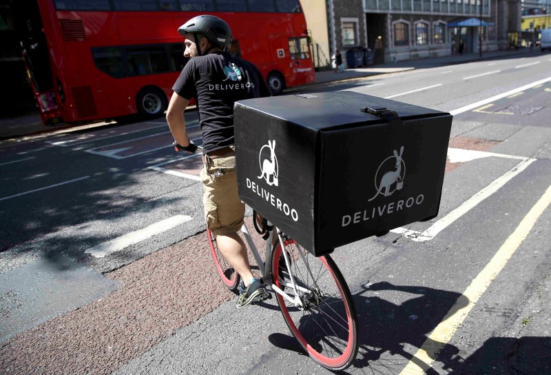 © Reuters. A Deliveroo worker rides his bicycle as he makes a delivery London