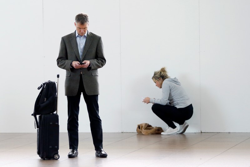 © Reuters. Passengers wait in the departure hall of Zaventem international airport near Brussels