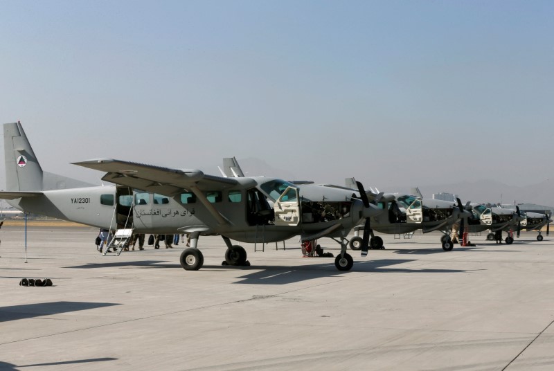 © Reuters. C208 cargo airplanes are parked at a military airfield in Kabul