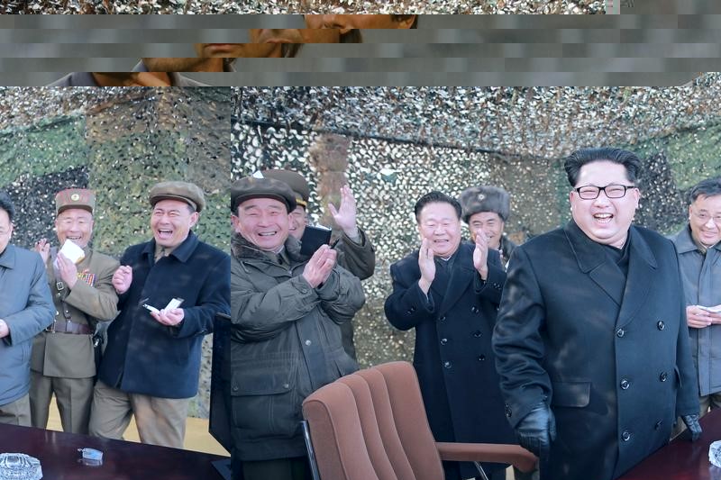 © Reuters. North Korean leader Kim smiles as he guides a test fire of a new multiple launch rocket system in this undated photo released by North Korea's KCNA in Pyongyang