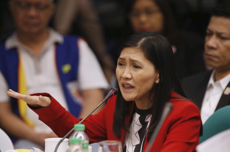 © Reuters. Maia Santos Deguito, a branch manager of the Rizal Commercial Banking Corp (RCBC) gestures as she testifies during a Senate hearing of money laundering involving $81 million stolen from  Bangladesh's central bank, at the Philippine Senate in Manila