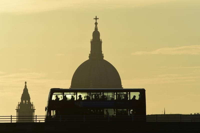 © Reuters. A bus carries commuters as it travels over Waterloo Bridge in London