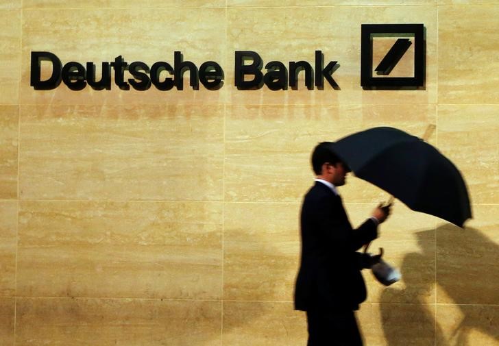 © Reuters. A man walks past Deutsche Bank offices in London