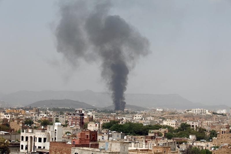 © Reuters. Smoke rises from a snack food factory after a Saudi-led air strike hit it in Sanaa