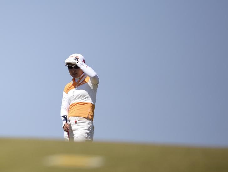 © Reuters. Uehara of Japan watches on the 9th hole during the women's British Open golf tournament at Royal Birkdale Golf Club in Southport